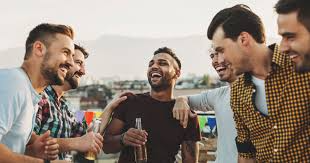 Group of men laughing and drinking