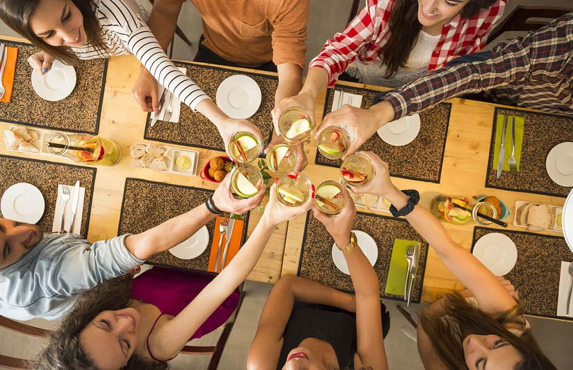 People dining and cheering their drinks
